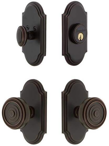Grandeur Arc Entry Door Set, Keyed Alike with Soleil Knobs in Timeless Bronze.